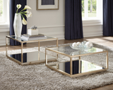 Rose brass 2-piece square occasional set in a modern living room setting