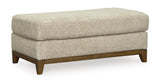 Modern Joseph ottoman in desert upholstery angle view